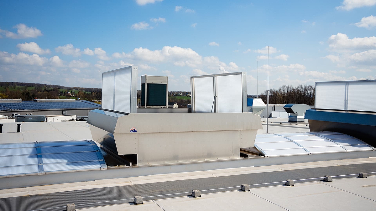 Lichtband B by roda with ventilation unit on an industrial flat roof.