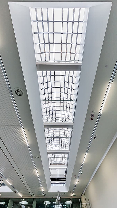 Lichtband B by roda used as skylight solution in a modern interior space.