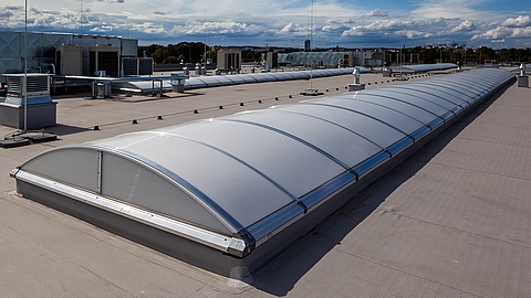 Continuous rooflight B from roda on a flat roof in daylight.