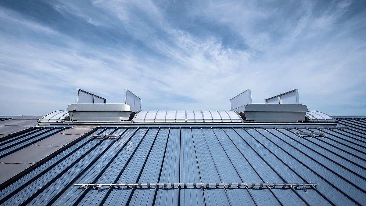 Lichtband B by roda with ventilation units on a sloped metal roof.